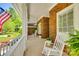Spacious front porch with rocking chairs and brick columns at 908 Thorn Ridge Ln, Lake Wylie, SC 29710