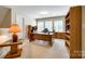 Bright home office with built-in shelving and large desk at 908 Thorn Ridge Ln, Lake Wylie, SC 29710