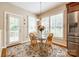 Charming kitchen breakfast nook with glass table and built in shelving at 908 Thorn Ridge Ln, Lake Wylie, SC 29710