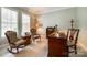 Home office with built-in wooden desk and two armchairs at 908 Thorn Ridge Ln, Lake Wylie, SC 29710