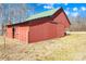 Red metal barn with green roof and large doors at 1047 College Ave, Shelby, NC 28152