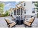 Expansive backyard with a patio, fire pit, comfortable seating, and a screened porch at 1103 N Sharon Amity Rd, Charlotte, NC 28211