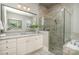 Modern bathroom featuring a tiled shower, soaking tub, and a vanity with granite countertop and a framed mirror at 1103 N Sharon Amity Rd, Charlotte, NC 28211