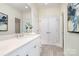 Bright bathroom featuring a large mirror, white cabinetry, quartz countertop, and modern fixtures at 1103 N Sharon Amity Rd, Charlotte, NC 28211