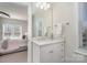 Bright bathroom vanity with stone countertop, decor, and a view to an adjacent bedroom at 1103 N Sharon Amity Rd, Charlotte, NC 28211