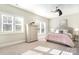 Bright bedroom featuring a large window and furnishings like a dresser and a comfortable bed at 1103 N Sharon Amity Rd, Charlotte, NC 28211