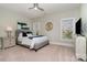 Comfortable bedroom with soft carpet, two windows, ceiling fan, and neutral colored walls at 1103 N Sharon Amity Rd, Charlotte, NC 28211