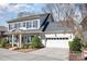 Charming two-story home with light gray brick, dark shutters, and a well-manicured front yard at 1103 N Sharon Amity Rd, Charlotte, NC 28211