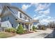 Charming two-story home with light gray brick, dark shutters, and a well-manicured front yard at 1103 N Sharon Amity Rd, Charlotte, NC 28211