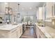 Open-concept kitchen with white cabinets, granite countertops, and stainless steel appliances; wine fridge in island at 1103 N Sharon Amity Rd, Charlotte, NC 28211