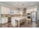 Stunning kitchen with white cabinets, granite countertops, stainless steel appliances, and a center island with seating at 1103 N Sharon Amity Rd, Charlotte, NC 28211