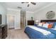 Bright main bedroom featuring a ceiling fan, dresser, and an ensuite bathroom entrance at 1103 N Sharon Amity Rd, Charlotte, NC 28211