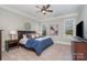 Comfortable main bedroom with a ceiling fan and an ensuite bathroom at 1103 N Sharon Amity Rd, Charlotte, NC 28211