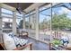 Inviting screened porch with comfortable seating, ceiling fan, and views of the backyard at 1103 N Sharon Amity Rd, Charlotte, NC 28211