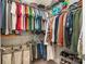 Organized walk-in closet featuring ample shelving and hanging space for clothing storage solutions at 1103 N Sharon Amity Rd, Charlotte, NC 28211