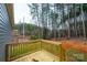 Wooden deck overlooking a wooded area with a glimpse of a rural road at 118 River Ridge Ln, Hickory, NC 28601