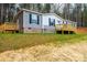 Gray manufactured home with large deck, offering a spacious outdoor area at 118 River Ridge Ln, Hickory, NC 28601