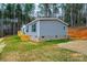 Gray manufactured home with deck and wooded backdrop at 118 River Ridge Ln, Hickory, NC 28601