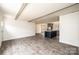 Open living room with exposed beams and gray wood-look flooring at 118 River Ridge Ln, Hickory, NC 28601