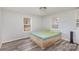 Simple bedroom with wood-look flooring and two windows at 125 Garden Ln, Salisbury, NC 28146