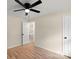 Light-filled bedroom with ceiling fan, hardwood floors and access to hallway at 126 Terrace Dr, Bessemer City, NC 28016