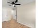 Bright bedroom with ceiling fan, hardwood floors, and ample closet space at 126 Terrace Dr, Bessemer City, NC 28016