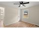 Bedroom with hardwood floors, ceiling fan, and a window overlooking the yard at 126 Terrace Dr, Bessemer City, NC 28016