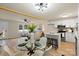 Open concept dining area with glass table and white kitchen at 126 Terrace Dr, Bessemer City, NC 28016