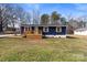 Newly renovated home with blue siding, wood deck, and landscaped lawn at 126 Terrace Dr, Bessemer City, NC 28016