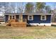 Charming blue home featuring a wood porch, white trim, and well-maintained front yard at 126 Terrace Dr, Bessemer City, NC 28016