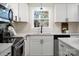Modern kitchen with white cabinets and stainless steel appliances at 126 Terrace Dr, Bessemer City, NC 28016