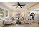 Cozy living room boasts a modern ceiling fan, natural light, and seamlessly connects to the kitchen at 126 Terrace Dr, Bessemer City, NC 28016