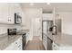 Modern kitchen with white cabinets, granite countertops and stainless steel appliances at 135 Jacobs Hill Pl, Troutman, NC 28166