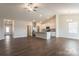 Open floor plan with hardwood floors connecting the living room and kitchen at 135 Jacobs Hill Pl, Troutman, NC 28166