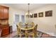 Charming breakfast nook with a glass-top table and ornate chairs at 14226 Carlton Woods Ln, Charlotte, NC 28278