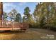 Wooden deck overlooking a spacious backyard and trees at 14226 Carlton Woods Ln, Charlotte, NC 28278