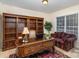 Home office with built-in shelving, desk, and comfortable seating at 14226 Carlton Woods Ln, Charlotte, NC 28278