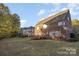 Brick house with a deck and a view of the backyard at 14226 Carlton Woods Ln, Charlotte, NC 28278