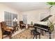 Elegant music room with grand piano and comfortable seating at 14226 Carlton Woods Ln, Charlotte, NC 28278