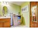 Well-lit bathroom with a wood vanity, decorative mirror, and a charming window showcasing nautical accents at 16338 Silver Rd, Oakboro, NC 28129