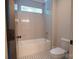 Bathroom with a shower/tub combo and black and white patterned floor at 1725 Dunkirk Dr, Charlotte, NC 28203