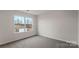 Bedroom showcasing natural light from the window and carpeted flooring at 1730 Falls Cove Rd, Newton, NC 28658