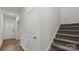 Hallway with a staircase, neutral color walls, wood floors, and access to the front entrance at 1730 Falls Cove Rd, Newton, NC 28658