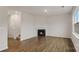 Bright living room showcasing wood floors, a modern fireplace, and ample natural light from a large window at 1730 Falls Cove Rd, Newton, NC 28658