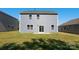 Grassy backyard view of home with gray siding, lawn and a sliding glass door at 1742 Falls Cove Rd, Newton, NC 28658