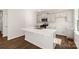 Stylish kitchen with white cabinets, stainless steel appliances, a large island, and hardwood floors at 1742 Falls Cove Rd, Newton, NC 28658