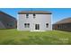 View of the home's exterior back, featuring two stories, and a well-manicured lawn at 1758 Falls Cove Rd, Newton, NC 28658