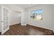 A bedroom with hardwood floors, a glass-paneled door, large windows, and light-colored walls at 1758 Falls Cove Rd, Newton, NC 28658