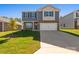 Attractive home featuring gray siding, stone accents, a two-car garage, and a well-maintained front yard at 1758 Falls Cove Rd, Newton, NC 28658
