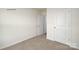 A carpeted bedroom showcases two white doors, one ajar, promising spaciousness and privacy at 1766 Falls Cove Rd, Newton, NC 28658